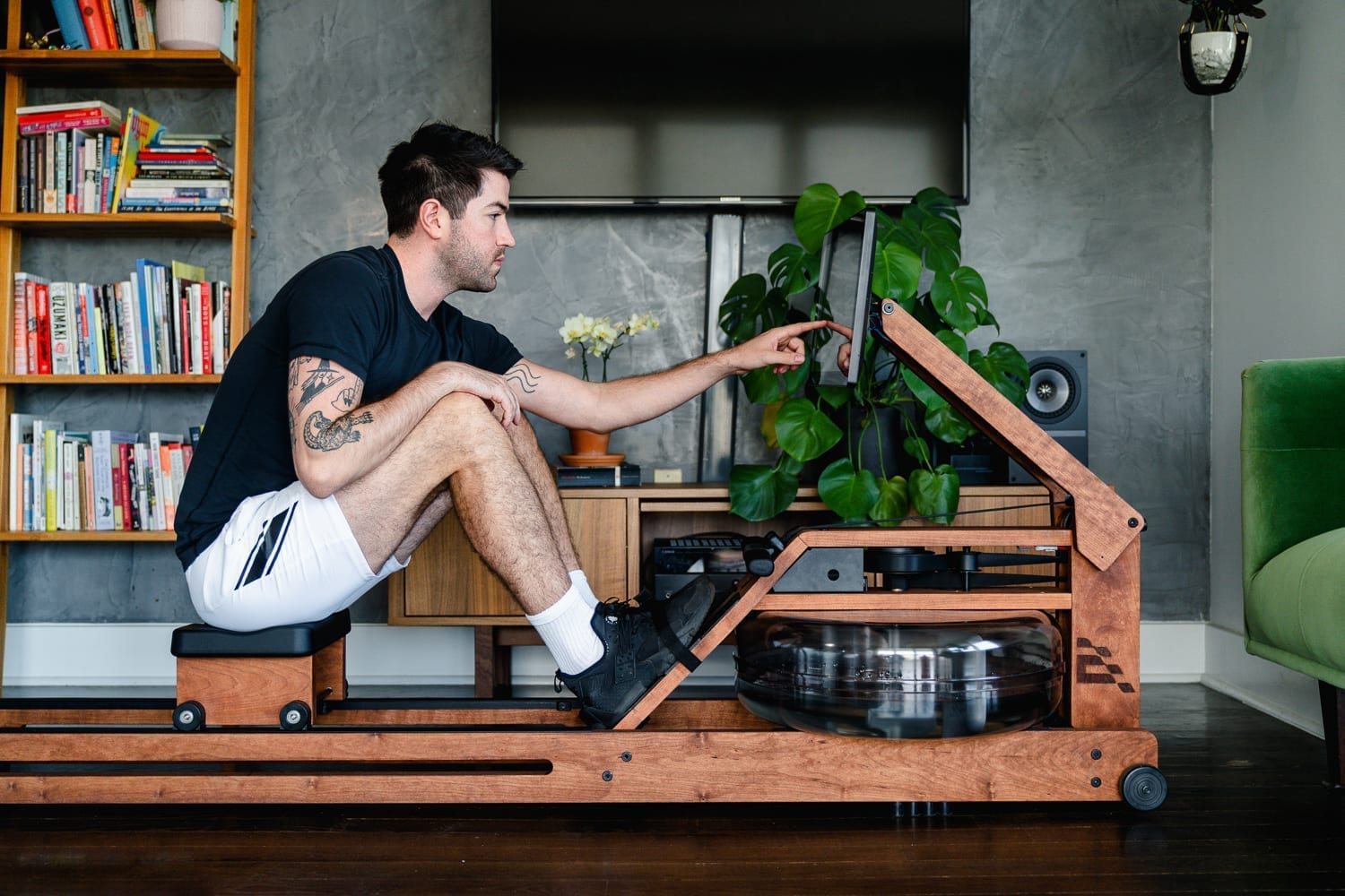 man using touchscreen of rower