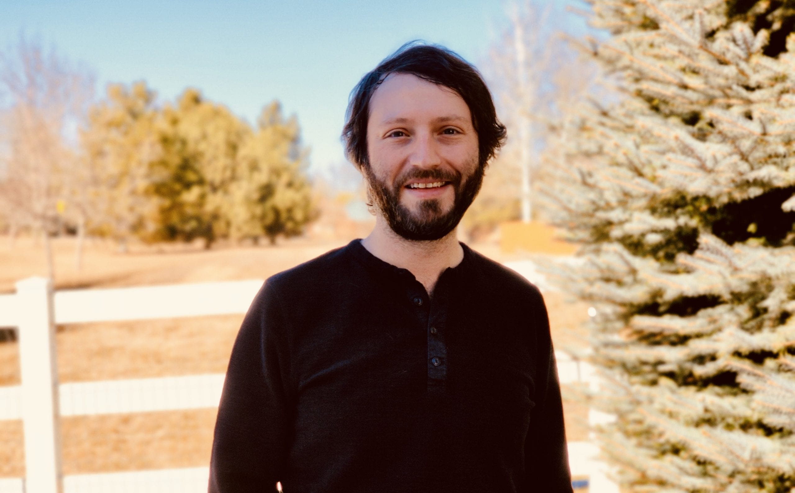 bearded employee smiling